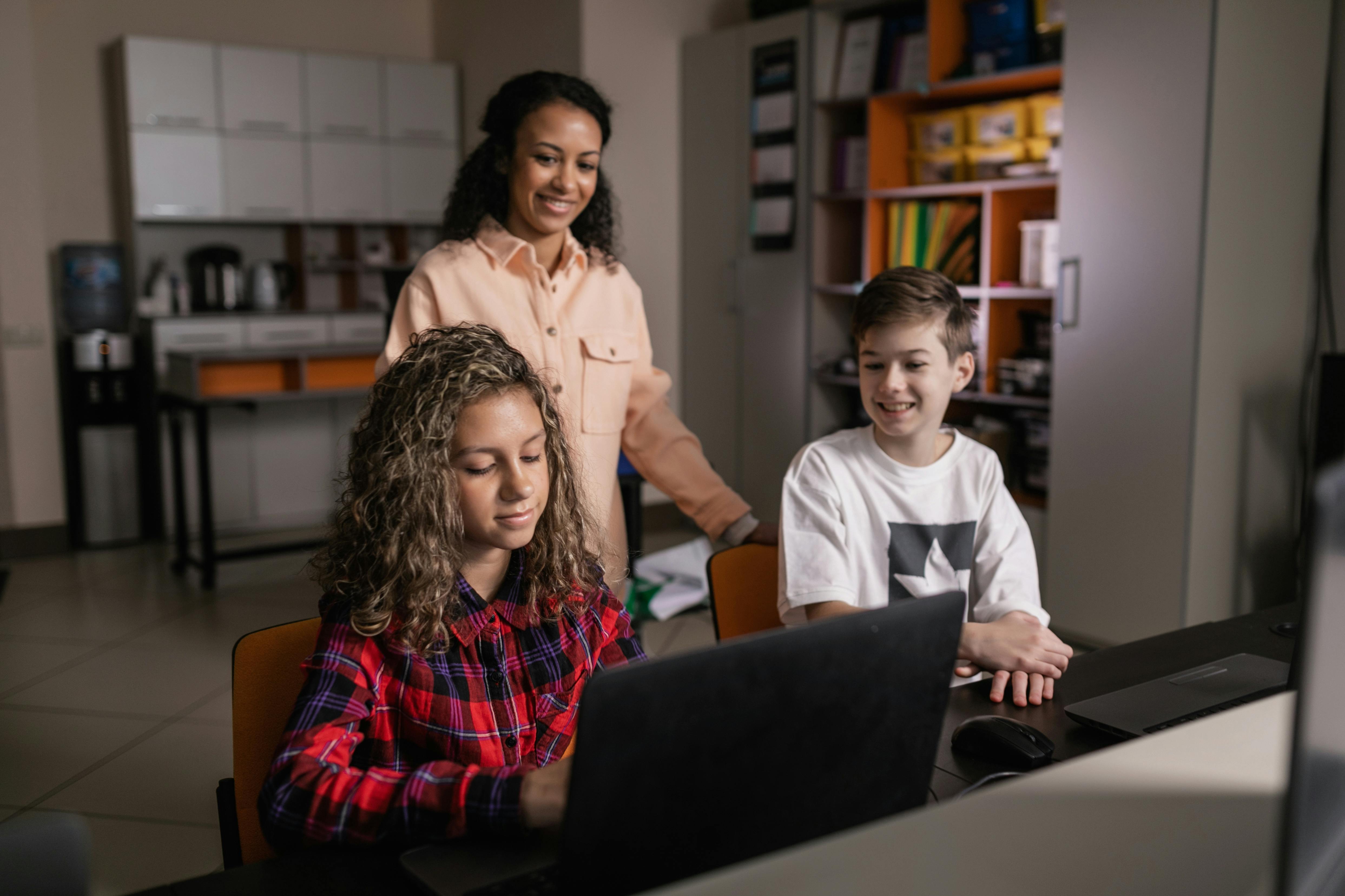 Children learning digital skills on a laptop